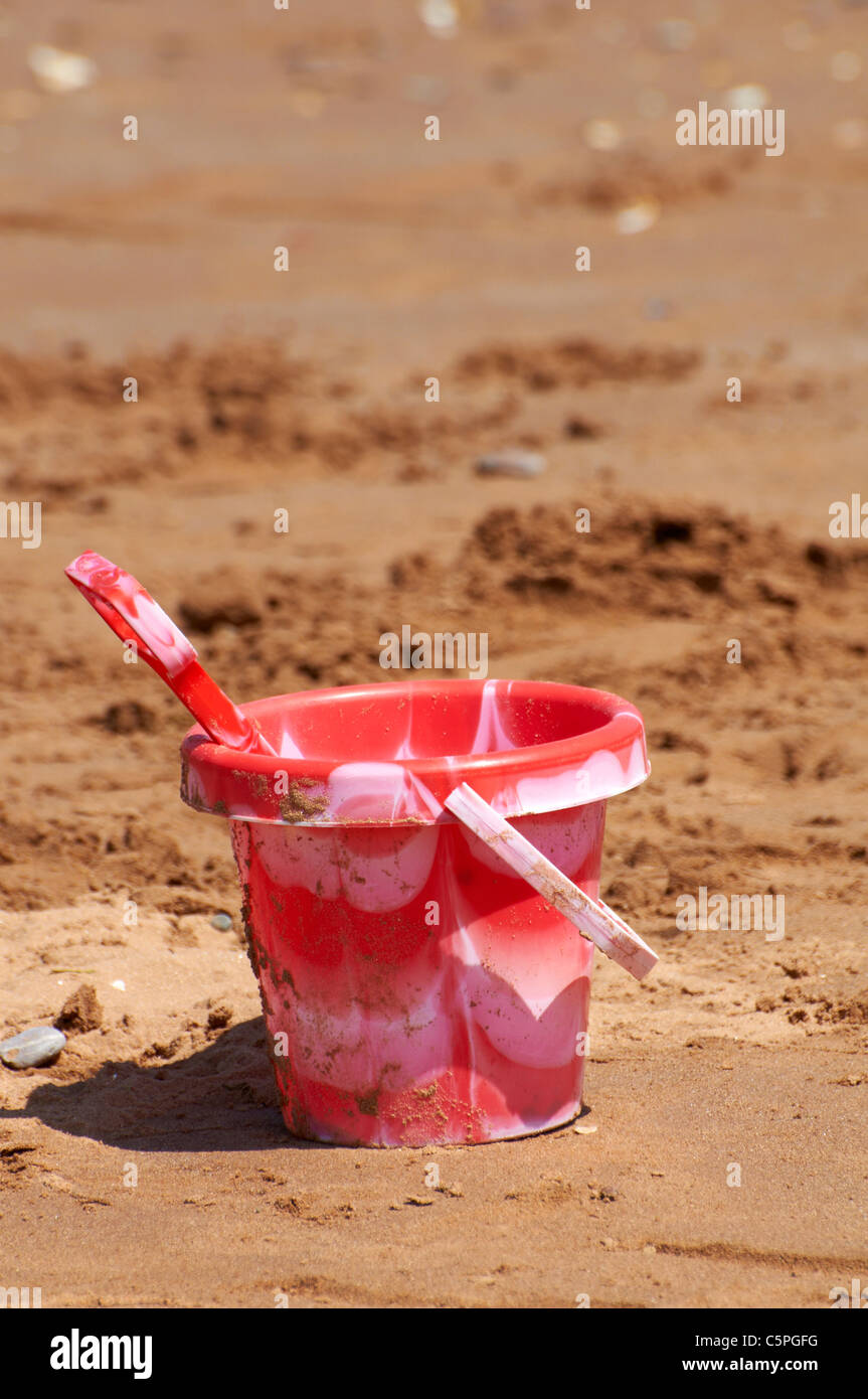 Plastic bucket and spade on a south Devon beach in England Stock Photo