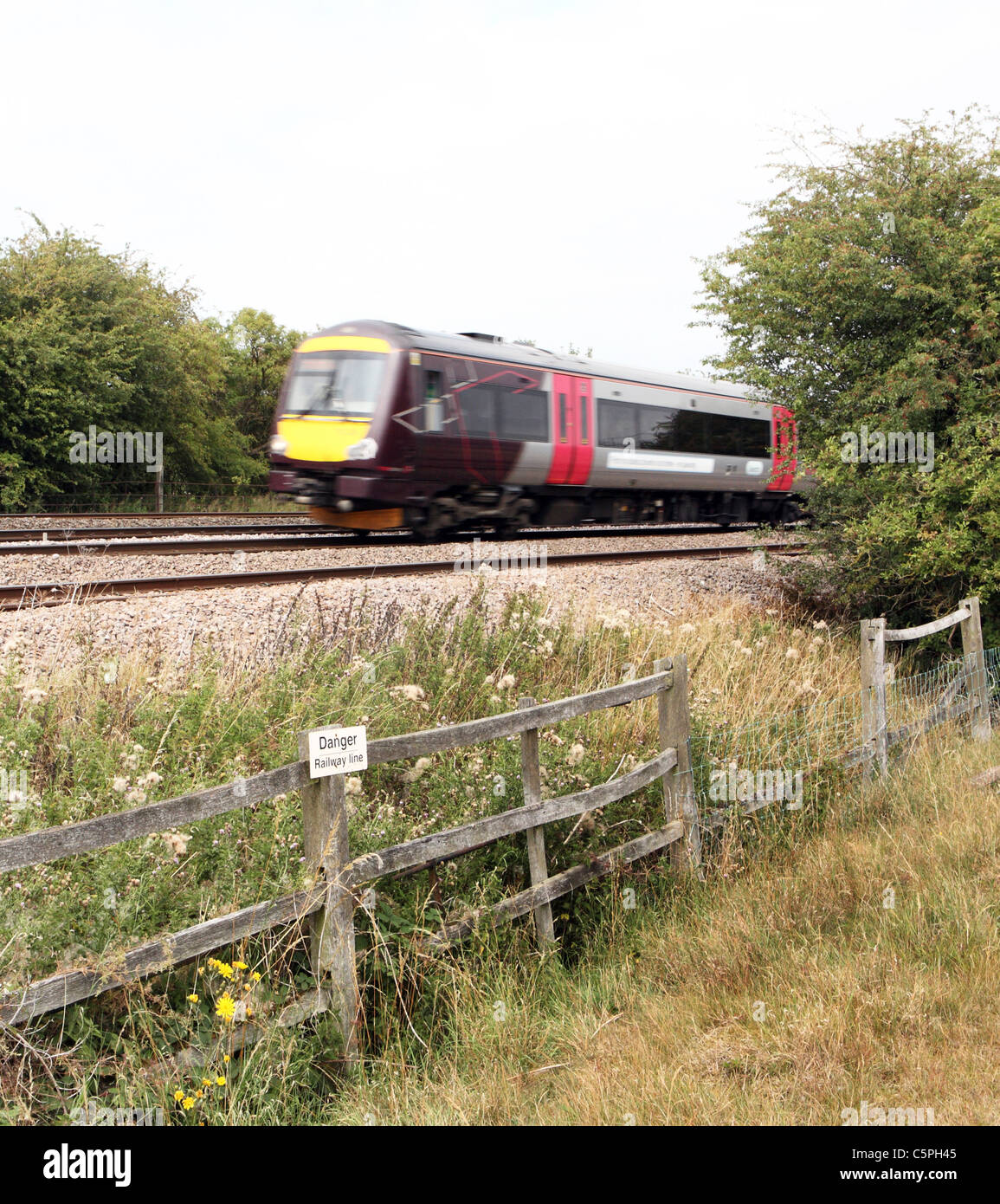 Commuter train on rails Stock Photo
