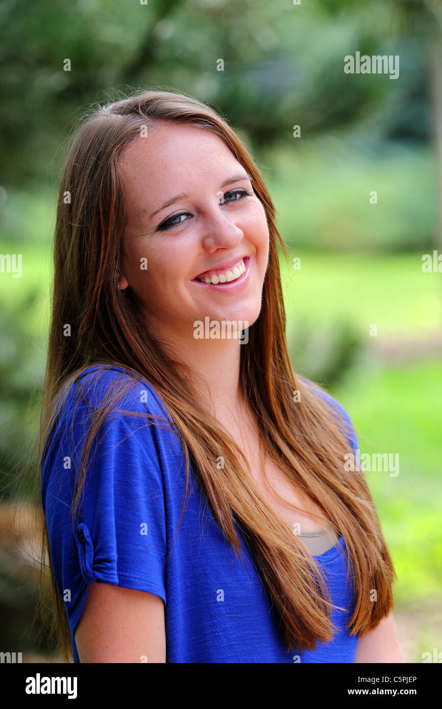 Portrait of a young woman in a park Stock Photo - Alamy