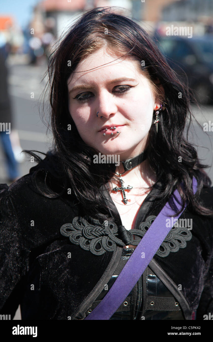 Whitby, Yorkshire, England, goth, gothic teen girl with piercings in lip emo angst with crucifix earings and necklace Stock Photo