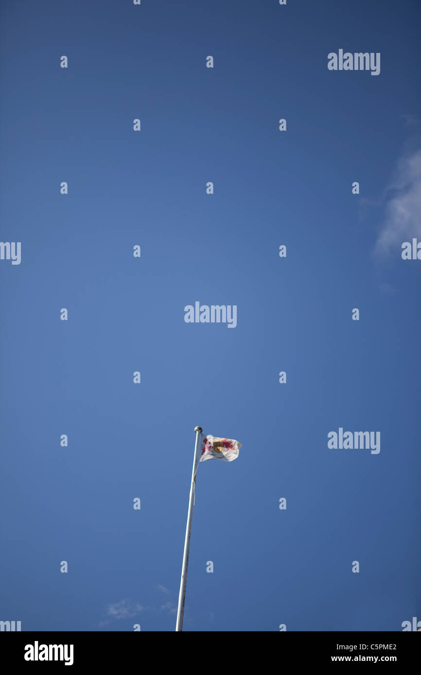 Flag wafting in the wind on a clear blue sky Stock Photo