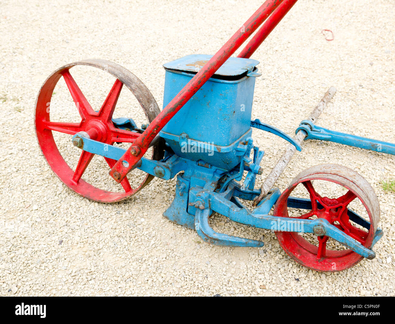 Old fashioned mechanical seed drill hand pushed to control even placing