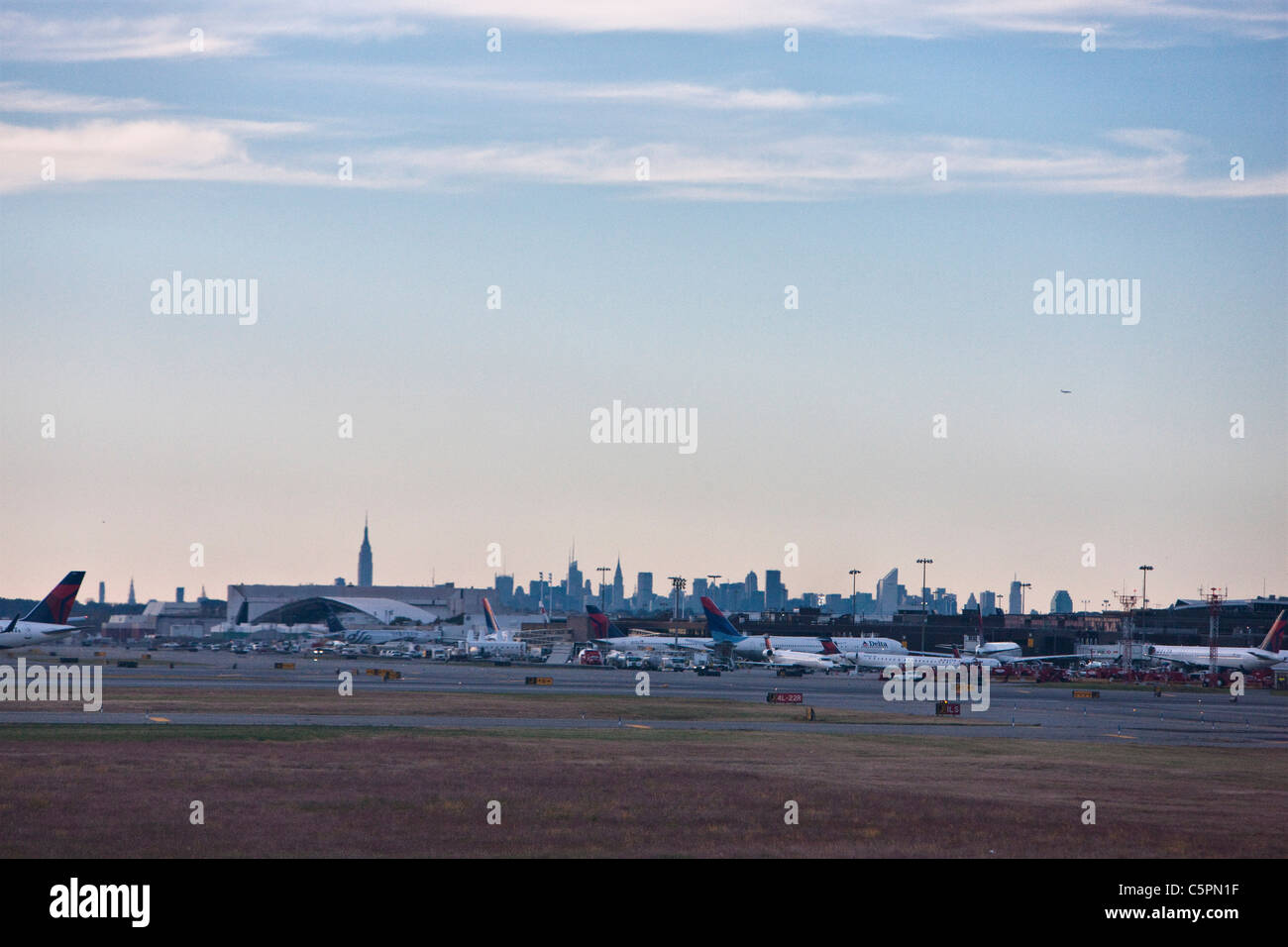 Manhattan skyline seen from John F. Kennedy International Airport with planes at their terminal