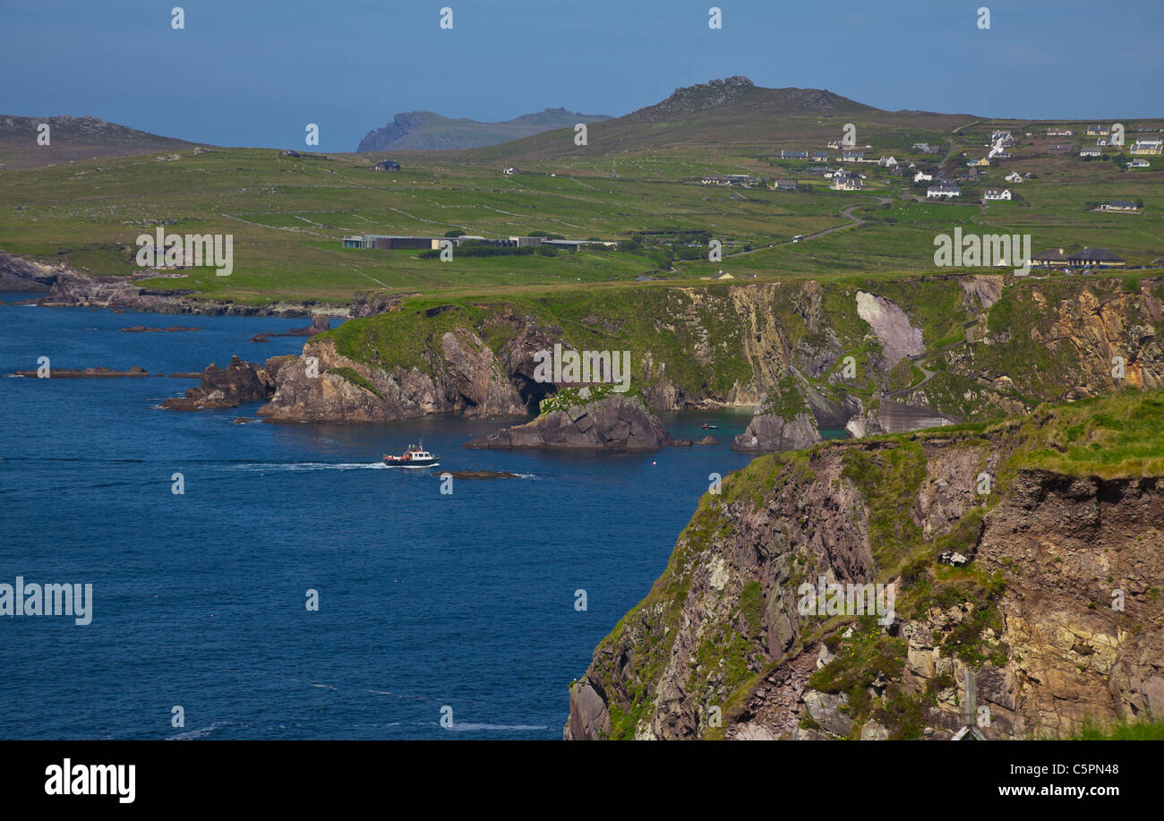 Landscape of coast of Dingle and ferry enterring Dunquin harbour and bay, Dingle Peninsula, Ireland. Stock Photo