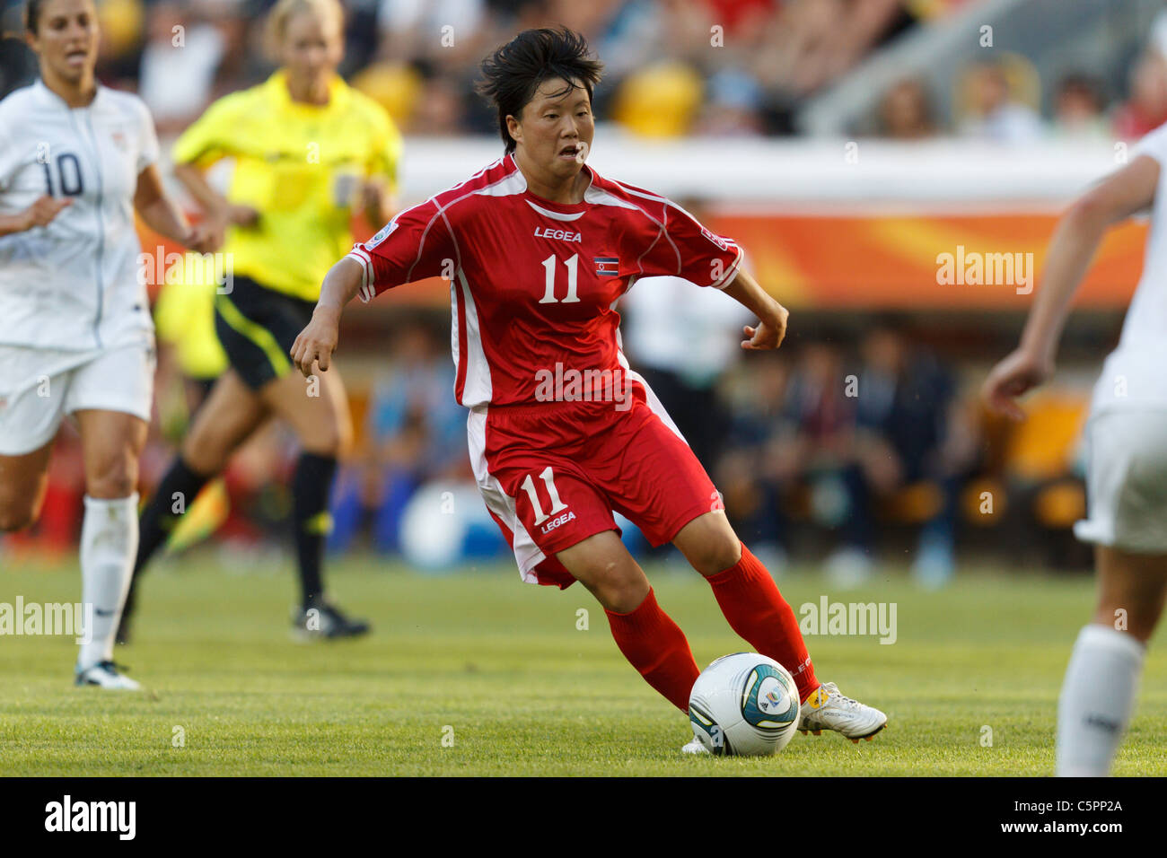 Ye Gyong Re of North Korea (11) looks for space against the United States during a 2011 FIFA Women's World Cup soccer match. Stock Photo