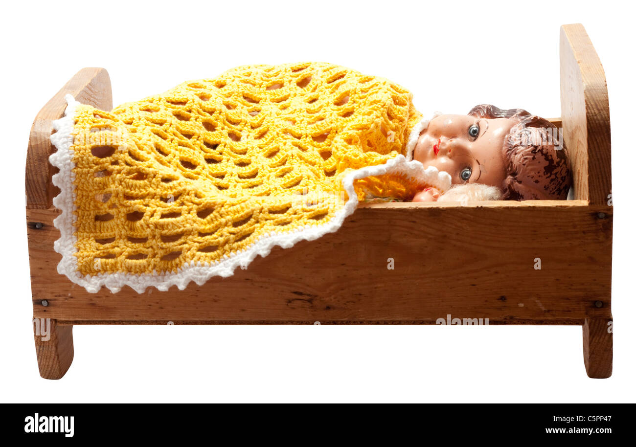 Antique dolls in an old vintage wooden doll's bed Stock Photo Alamy