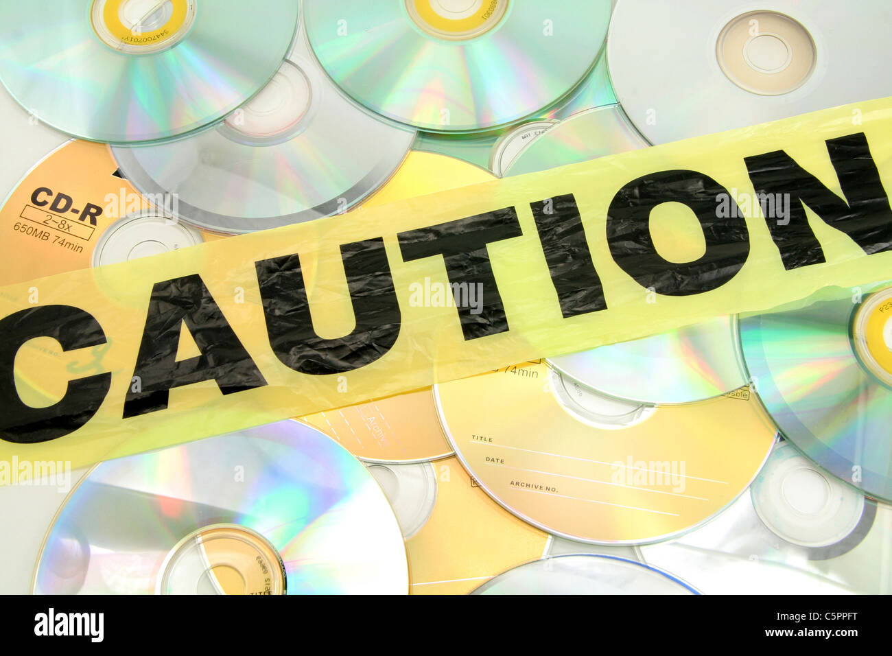 plastic caution tape and CD, computer crime Stock Photo - Alamy