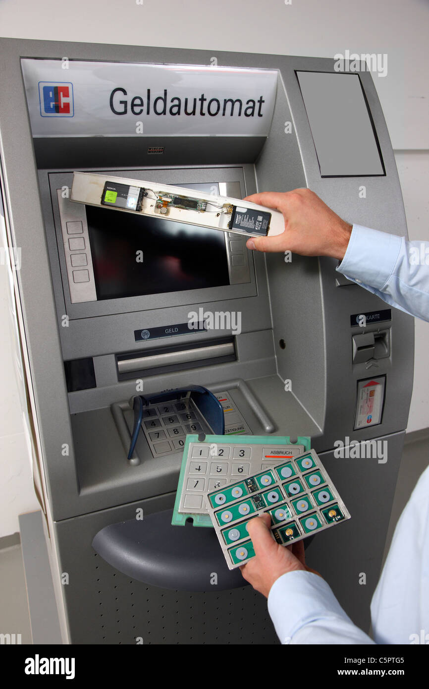 Skimming devices for manipulation a cash machine, ATM. MIcro cameras or keyboards register the PIN code of a bank card. Stock Photo