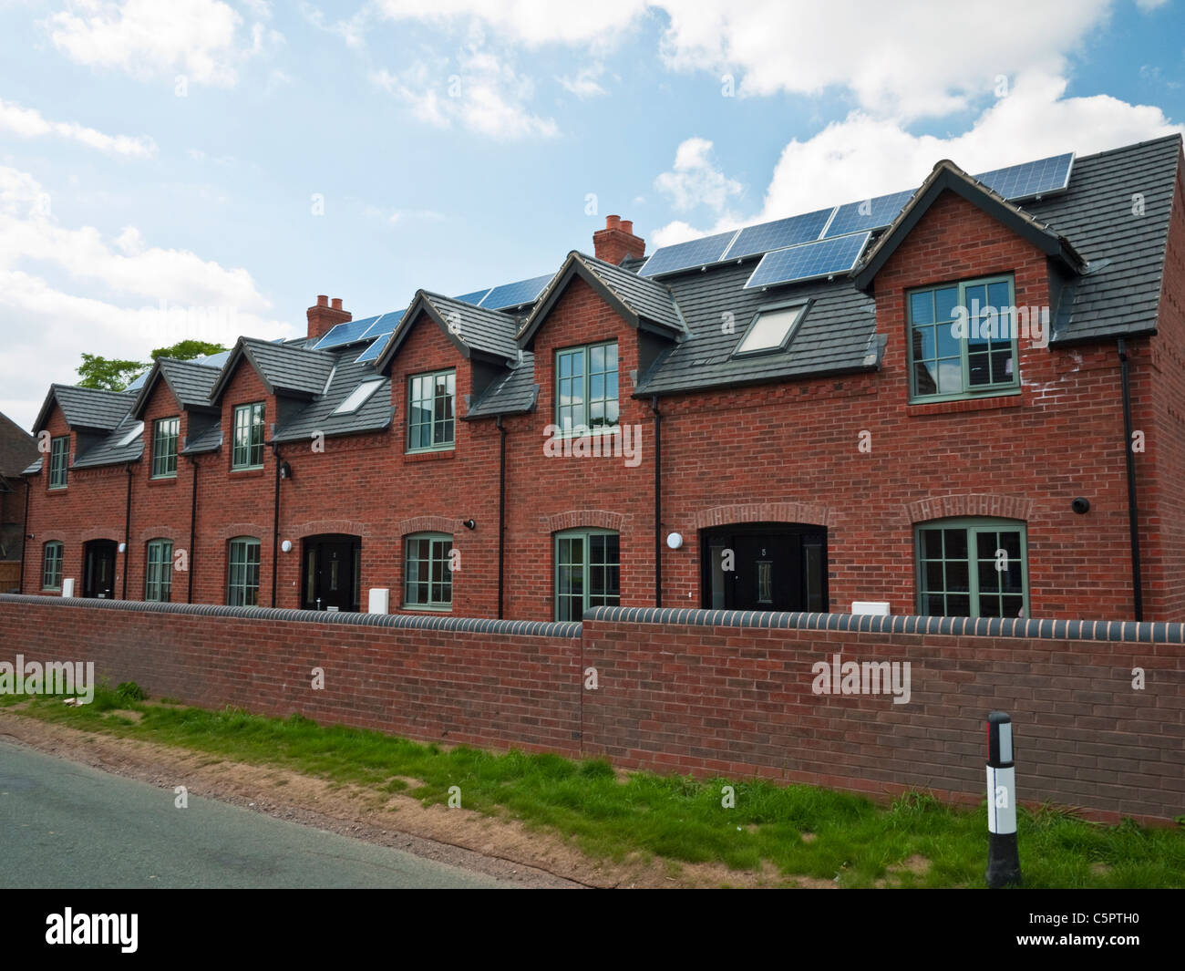 Solar PV panels mounted on a new housing development in the South Staffordshire village of Swindon Stock Photo