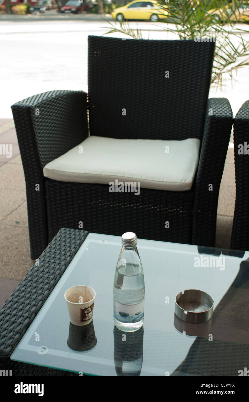 Coffee and a bottle of mineral water on table Stock Photo Alamy