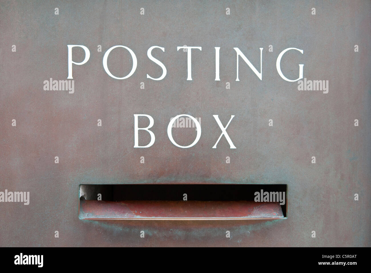 An old style metallic ‘Posting Box’ displays the effect of corrosion and wear. Stock Photo