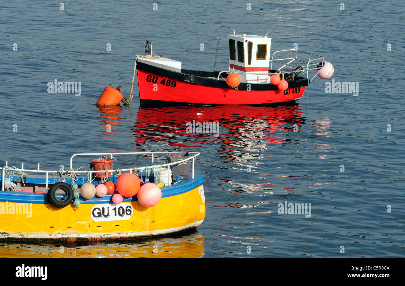 Fishing boats in moored in the shelter of the massive victorian Braye Harbour breakwater.  Alderney, Channel Islands, UK. Stock Photo