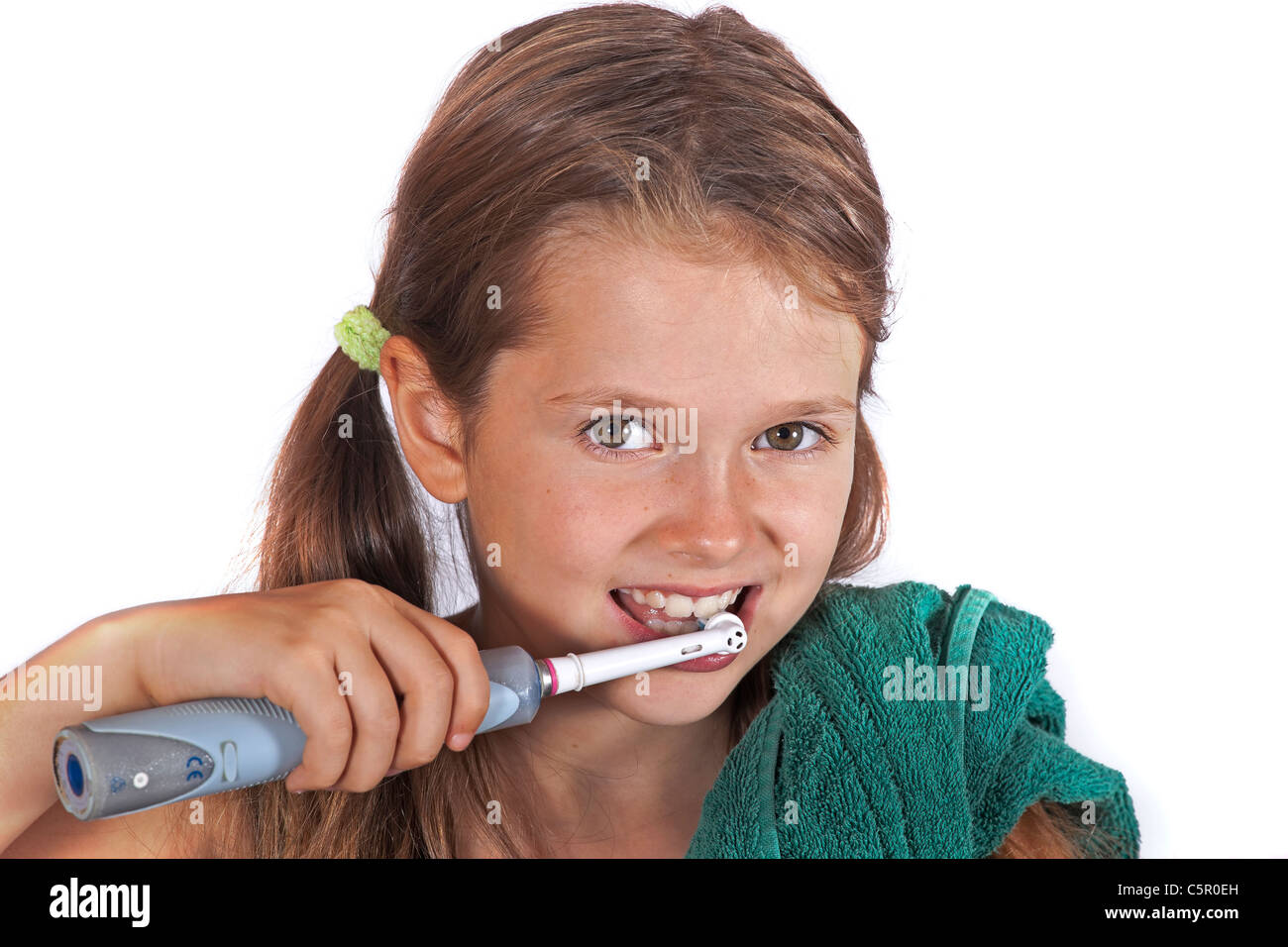 eight year old girl with a toothbrush and a towel to clean the teeth