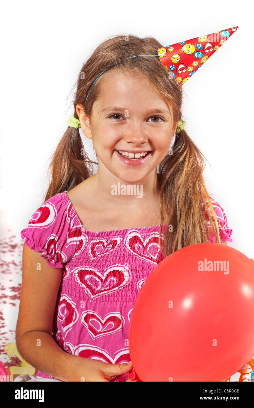 eight year old girl with party hat and trumpet on a children's festival