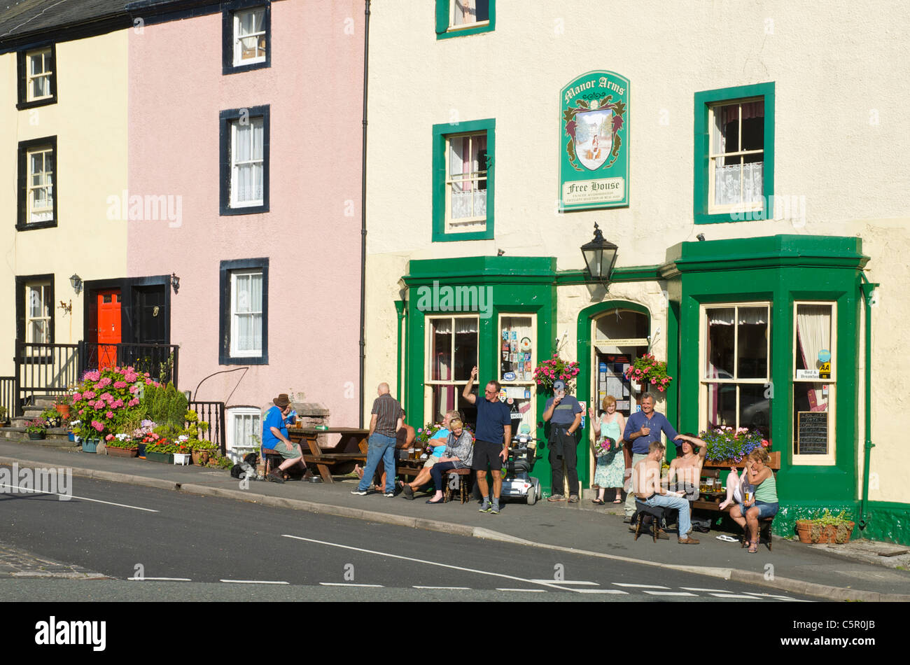 People enjoying a drink outside the Manor Arms, a 'real ale' pub in Broughton, Cumbria, England