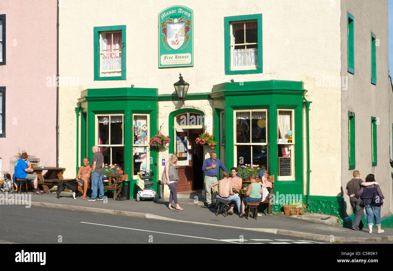 People enjoying a drink outside the Manor Arms, a 'real ale' pub in Broughton, Cumbria, England