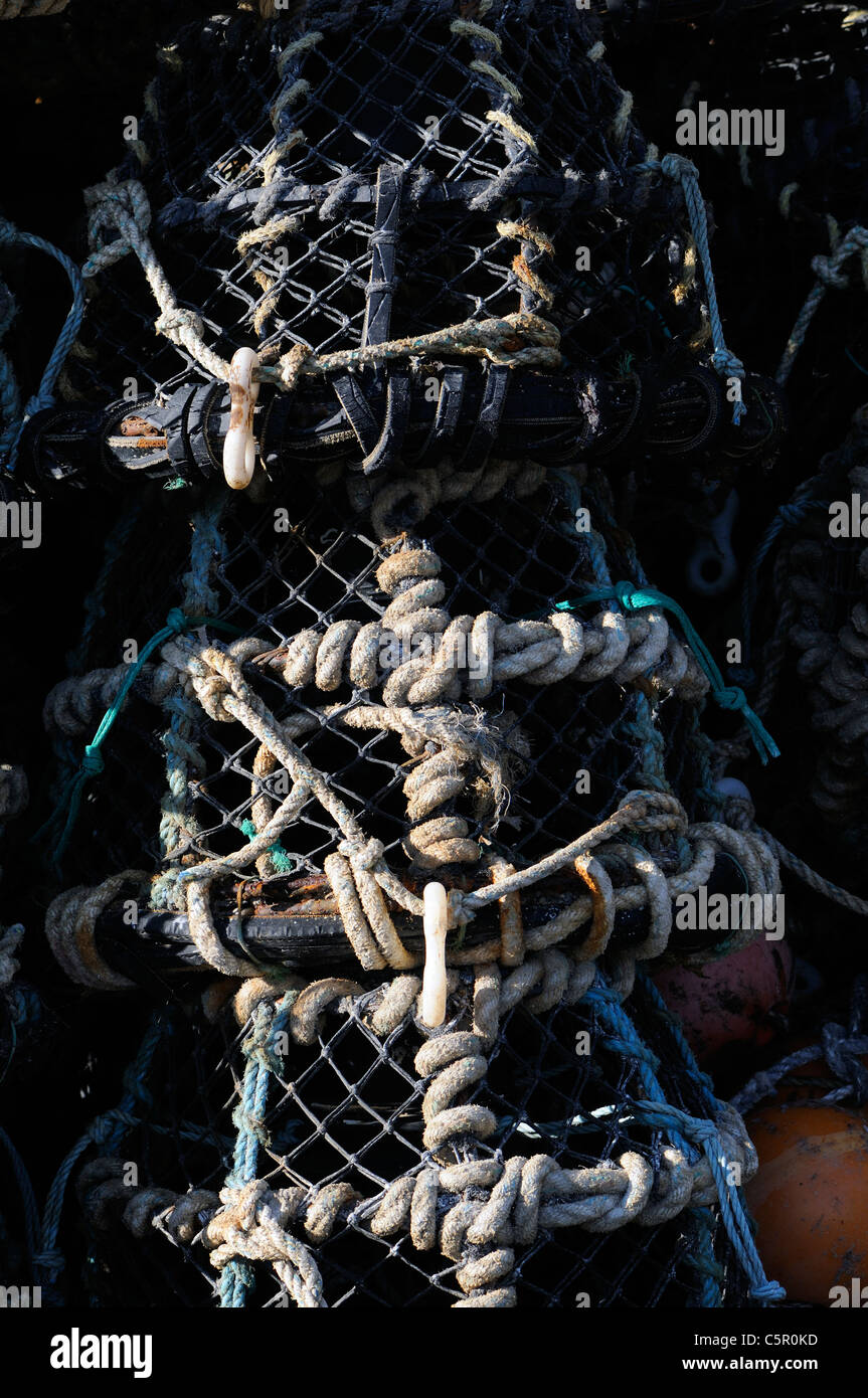 A stack of crab pots on  Braye Harbour breakwater.  Alderney, Channel Islands, UK. Stock Photo