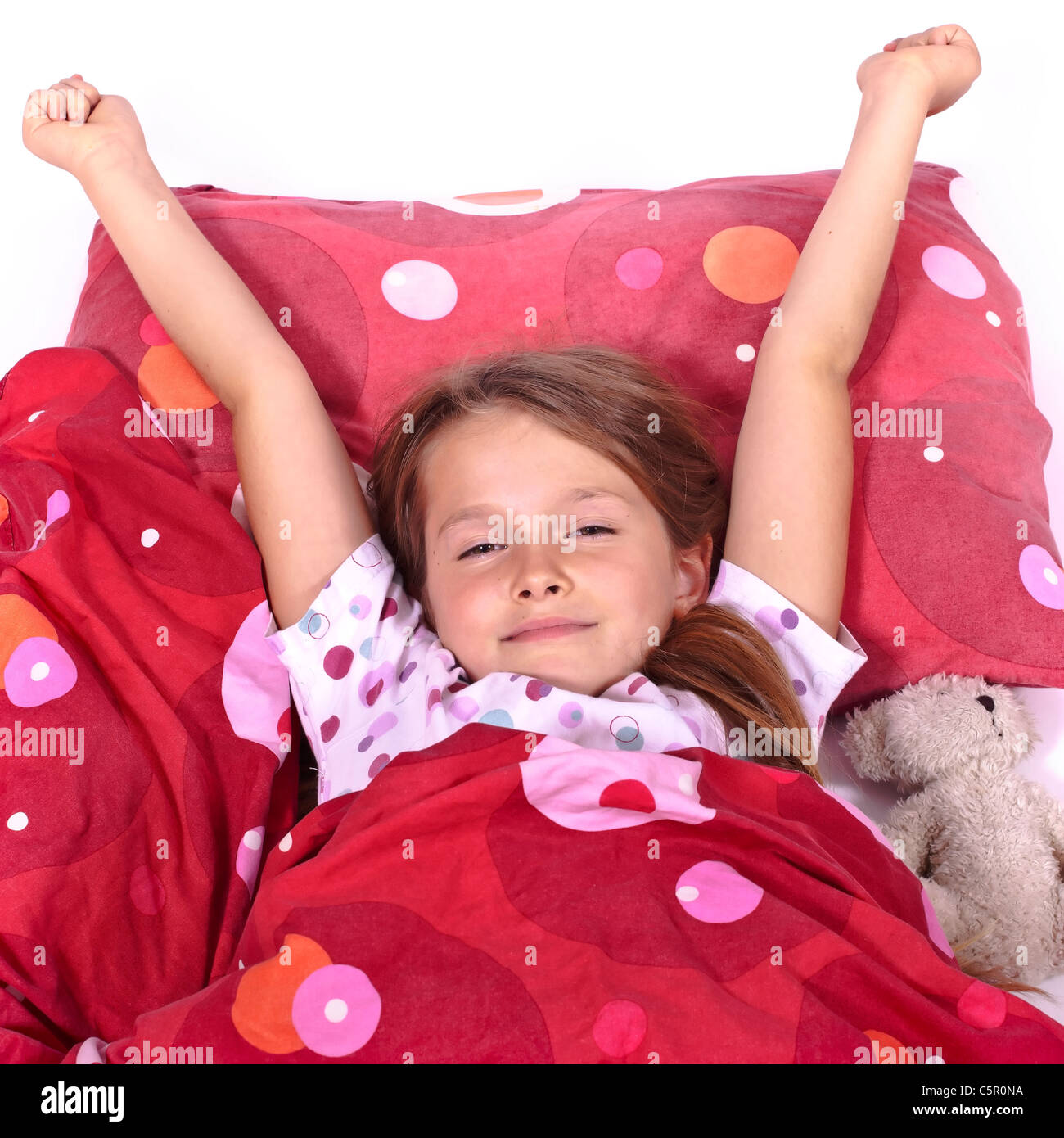 Eight year old girl in bed blanket hires stock photography and images