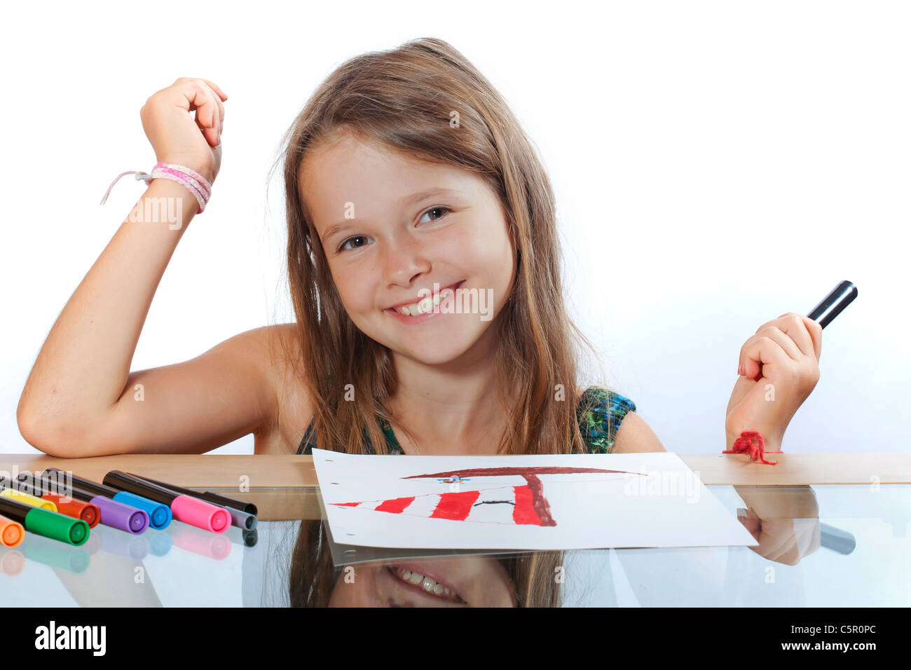 eight year old girl draws a picture with markers Stock Photo