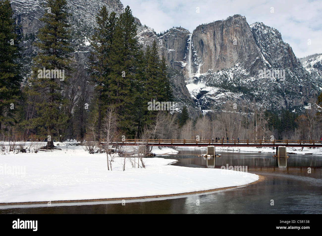 Merced River with Yosemite Falls in the background during winter, Yosemite National Park, California, United States of America Stock Photo