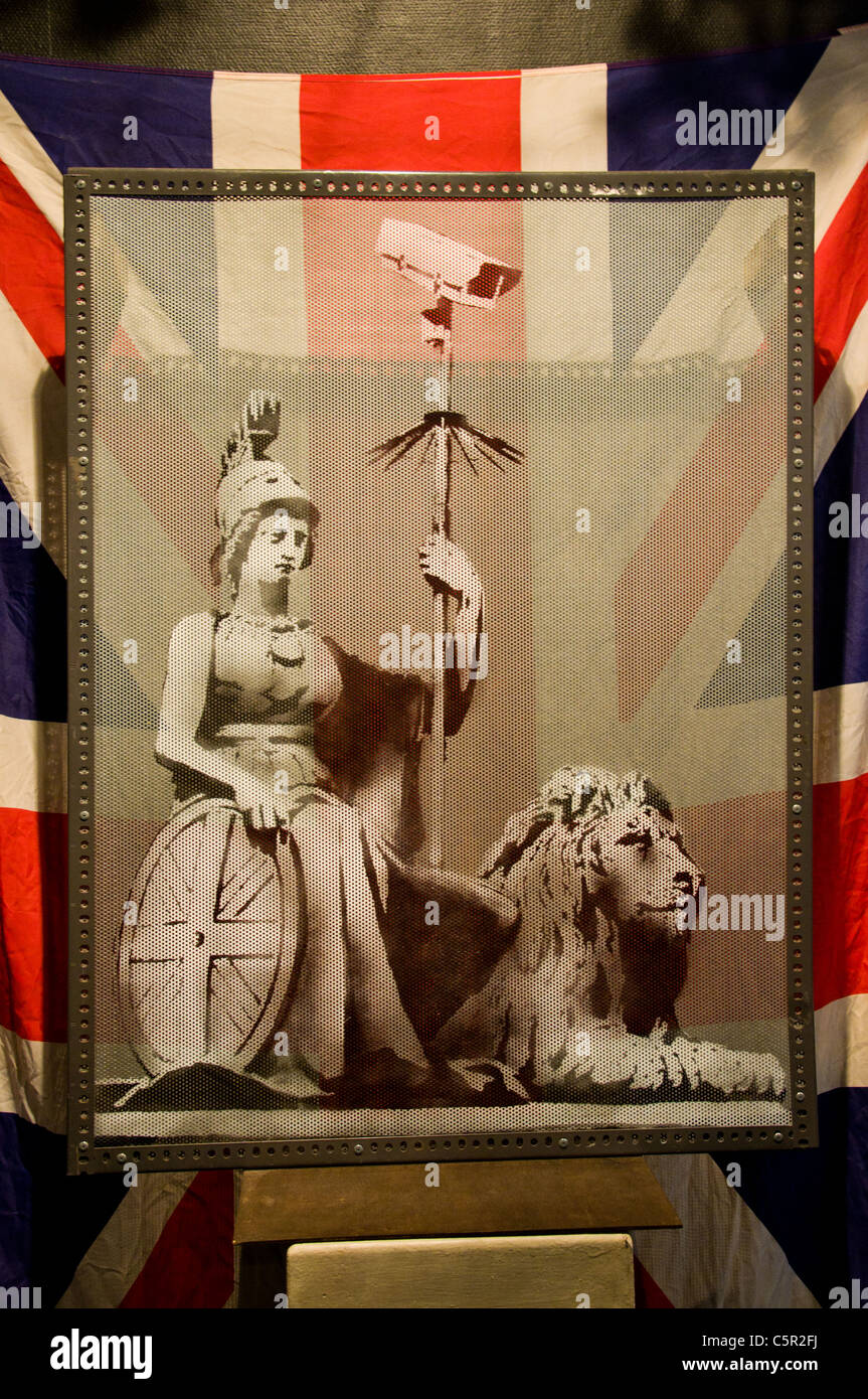 Banksy picture of Britannia holding a CCTV camera against a union jack, Bristol, England Stock Photo