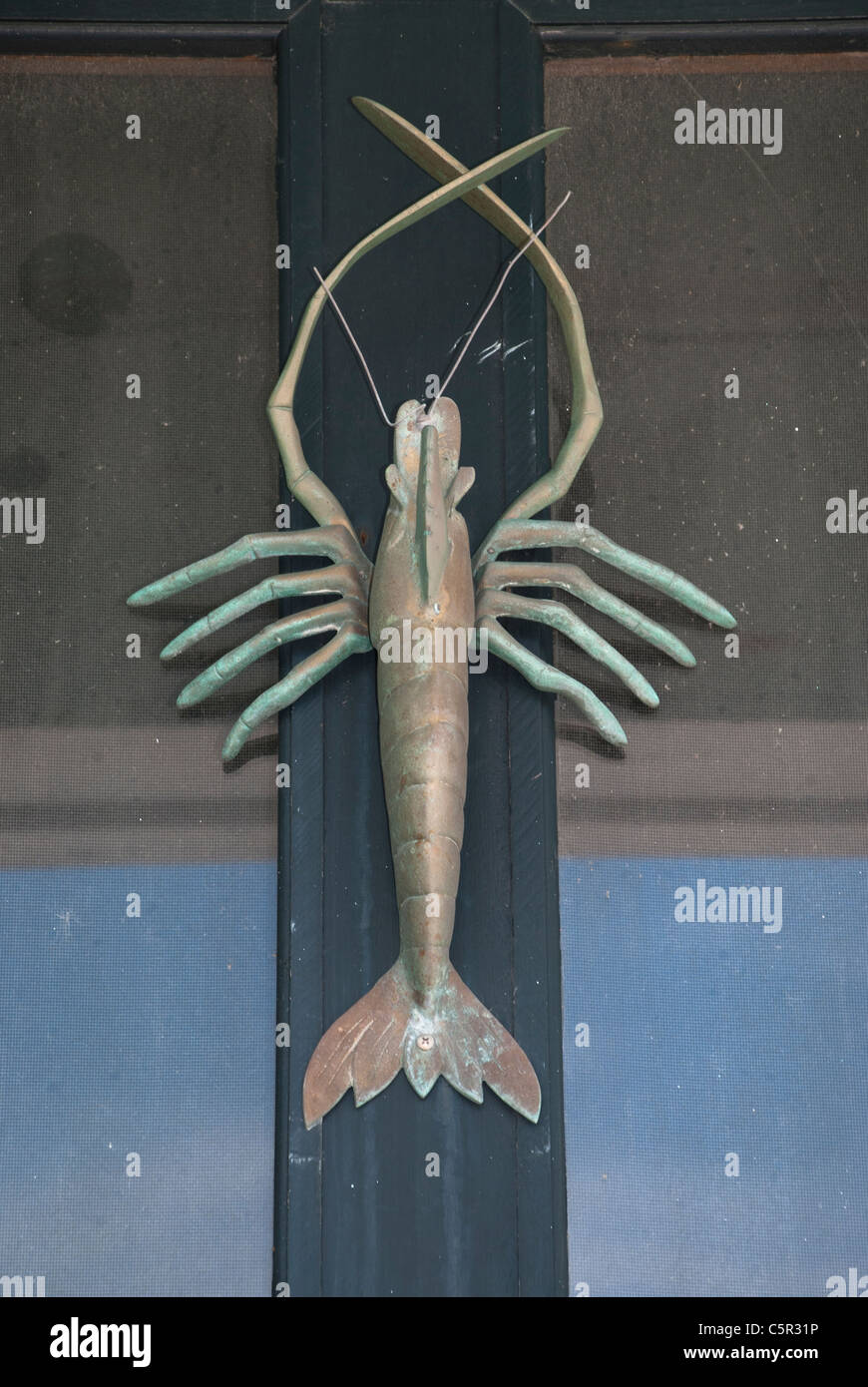 An ornate copper lobster makes an interesting door-knocker Stock Photo