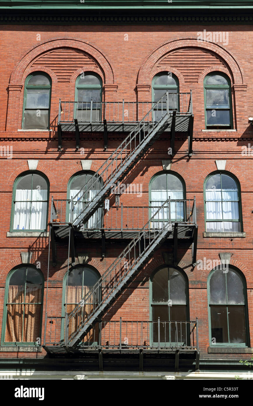 An old building complete with fire escapes in downtown Bangor, Maine, USA. Stock Photo