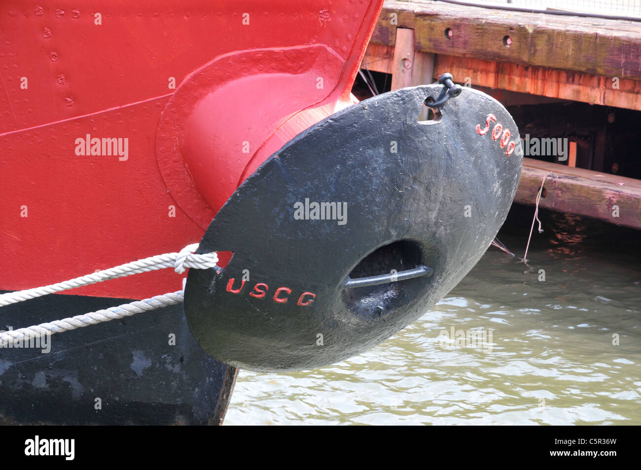 Detail of ship with black anchor and red shipboard, South Street Seaport, Manhattan, New York, NY, USA Stock Photo