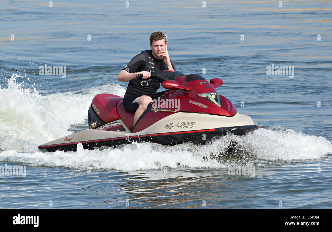 Bored man on Jet ski / jetski - inexplicably disinterested Stock Photo