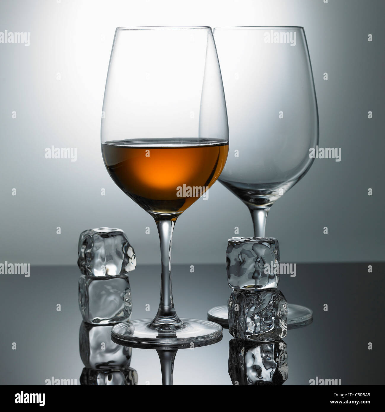 Liquor glass and ice cubes Stock Photo Alamy