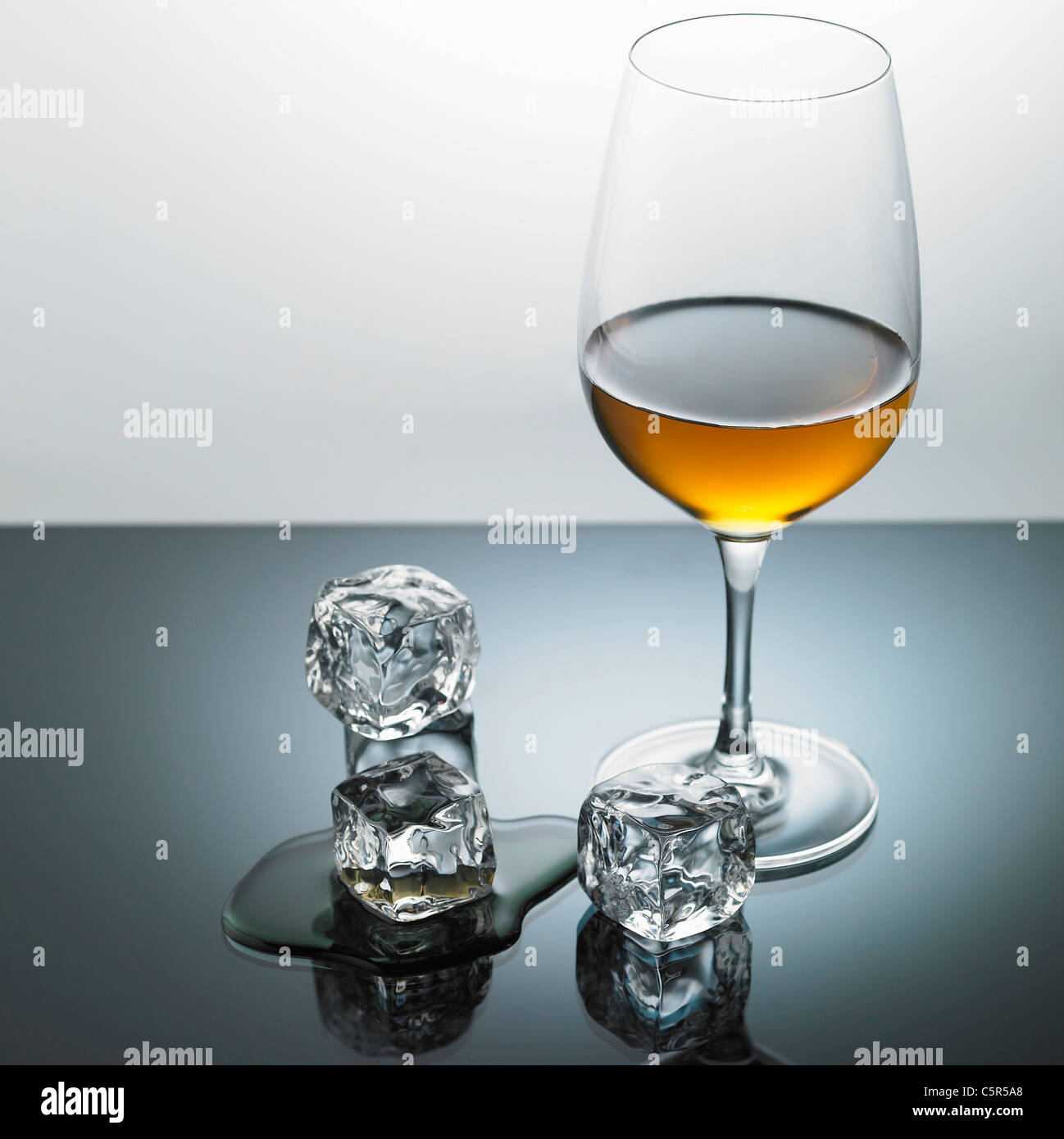Liquor glass and ice cubes Stock Photo Alamy