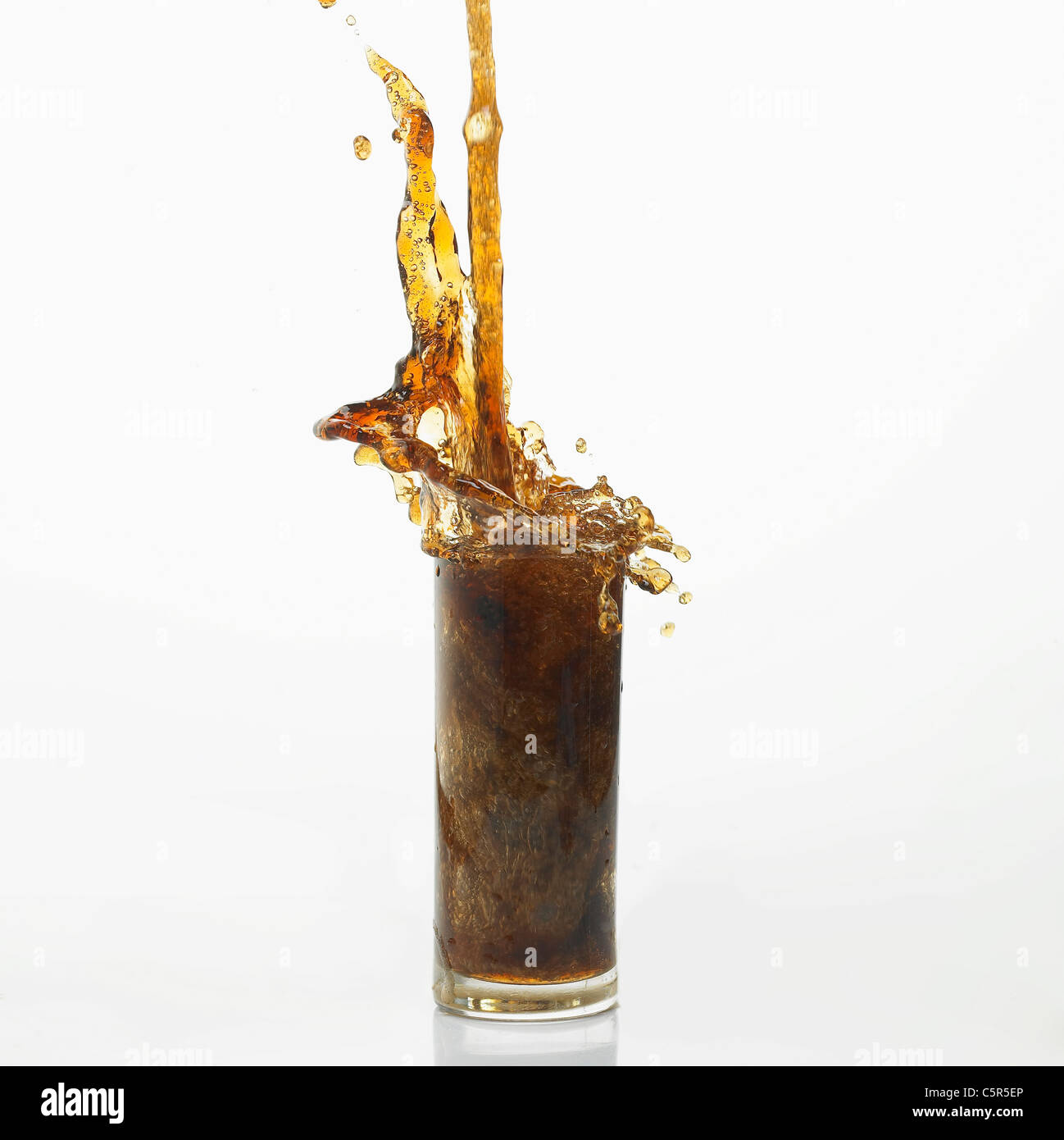 Coke pouring down to a glass Stock Photo