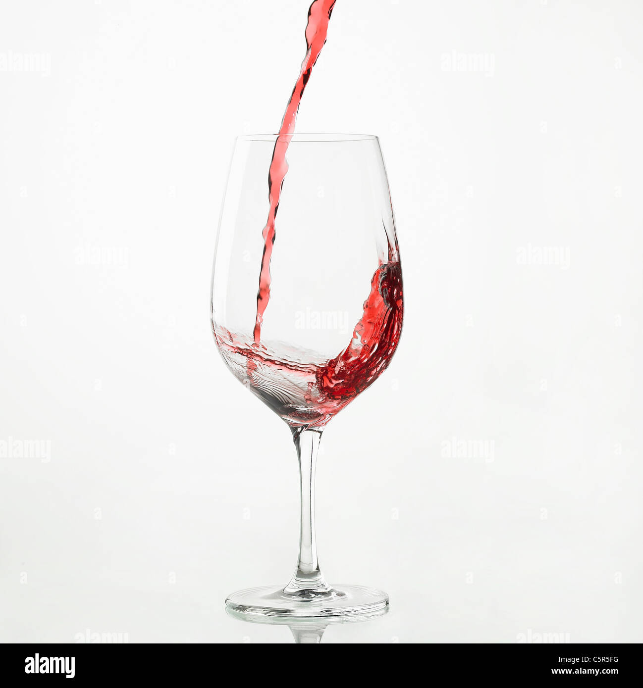 Circle shaped wine drops falling into glass closeup. Stock Photo by  stockbusters