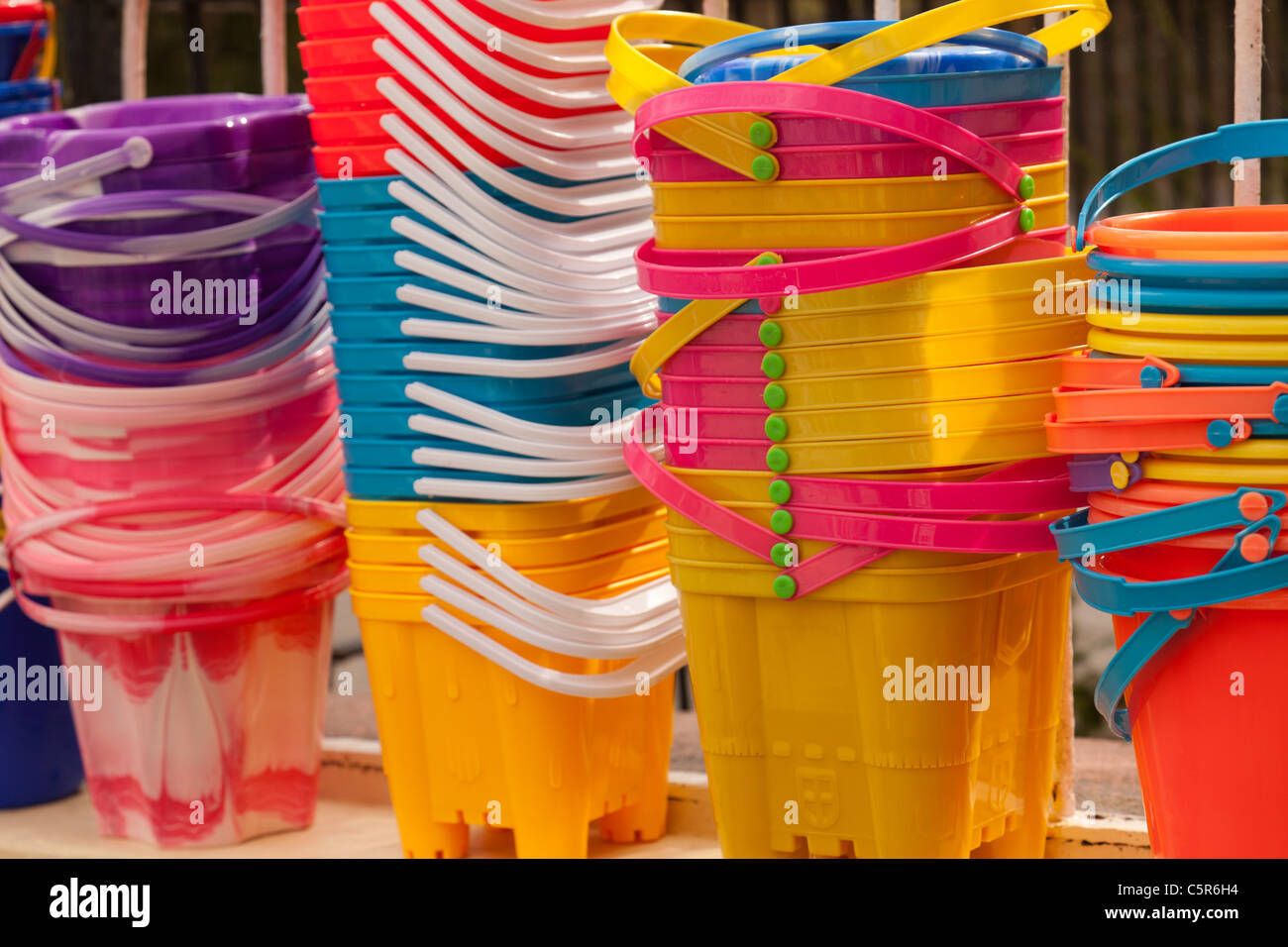 Brightly coloured children's plastic beach buckets Stock Photo Alamy