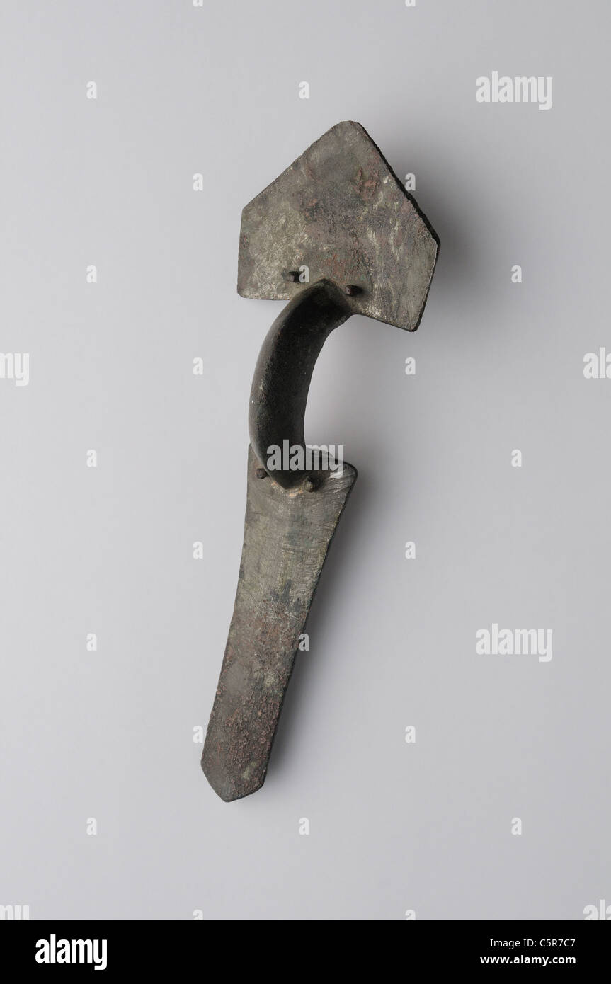 Bronze Fibula arc trilaminar,consists of three pieces hammered together by nails . Visigoth period in Complutum . SPAIN Stock Photo