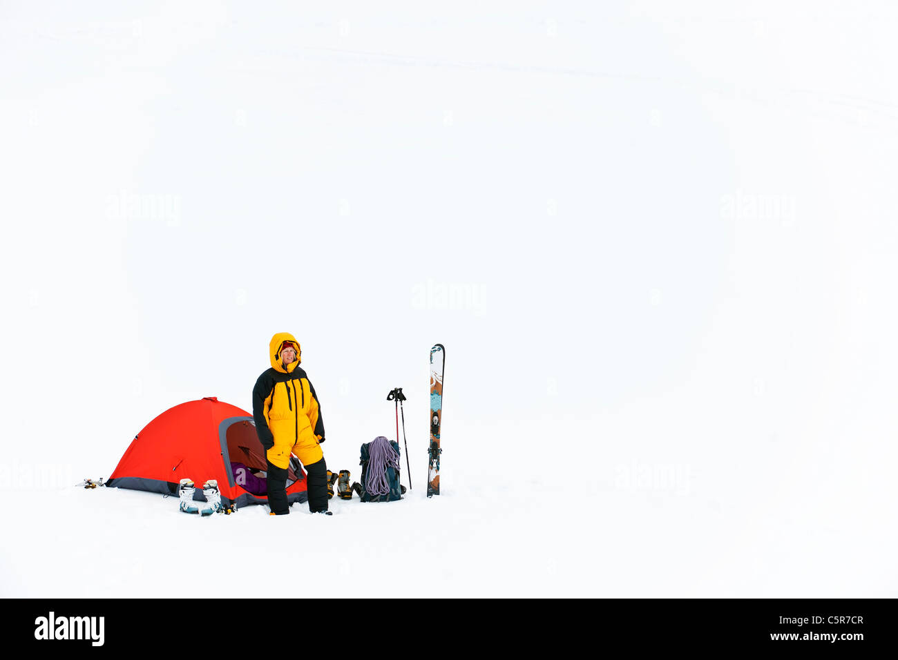 A mountaineer at base camp in a feather down suit. Stock Photo