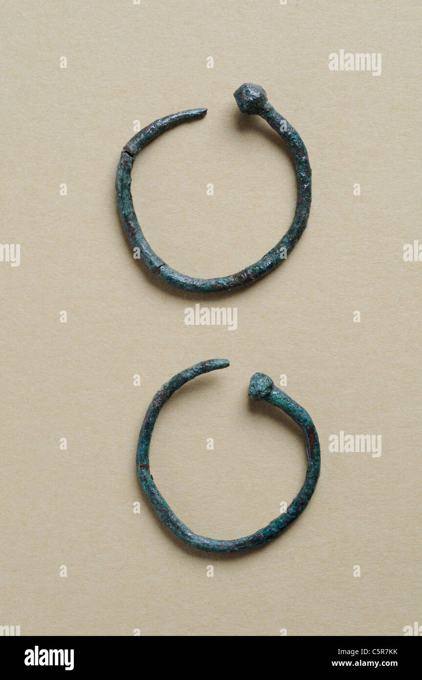 Two earrings circular bronze decorated with ball end . Roman period in Complutum . SPAIN Stock Photo