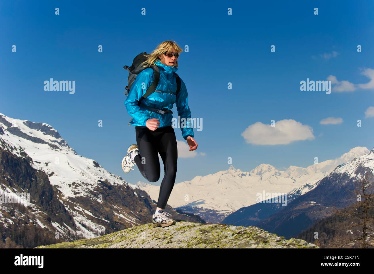 Girl jogging on top of the World. Stock Photo