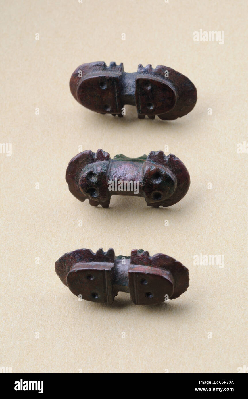 Three bronze buttons of similar proportions with incised decoration. Visigoth period in Complutum . SPAIN Stock Photo