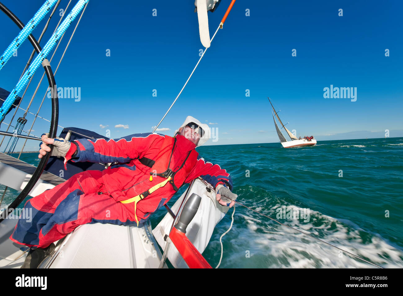 Captain steering Ocean going yacht in race Stock Photo