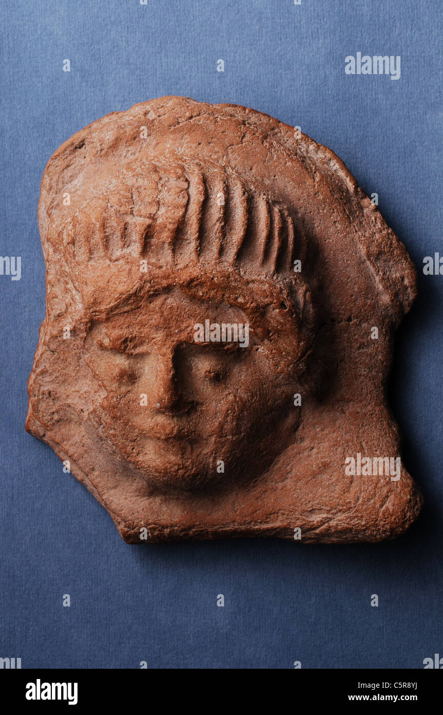 Antefixes of terracotta representing female head . Roman period in Complutum . SPAIN Stock Photo