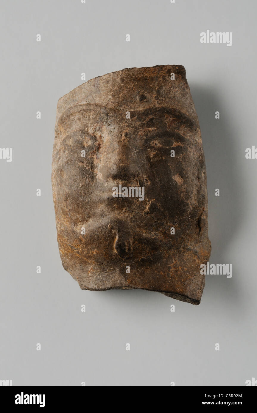 Male head of terracotta figurine. Height 4, 1 cm width 2.2 cm (1 st - 3 rd CE ) - Roman period in Complutum . SPAIN Stock Photo