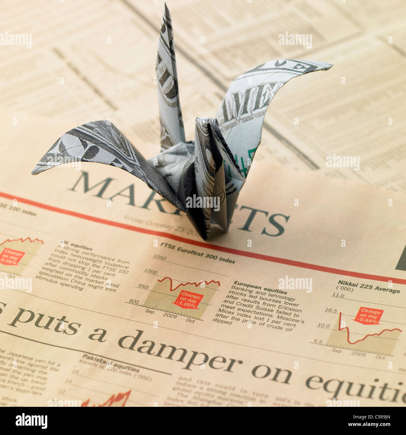 A paper crane made of paper money Stock Photo