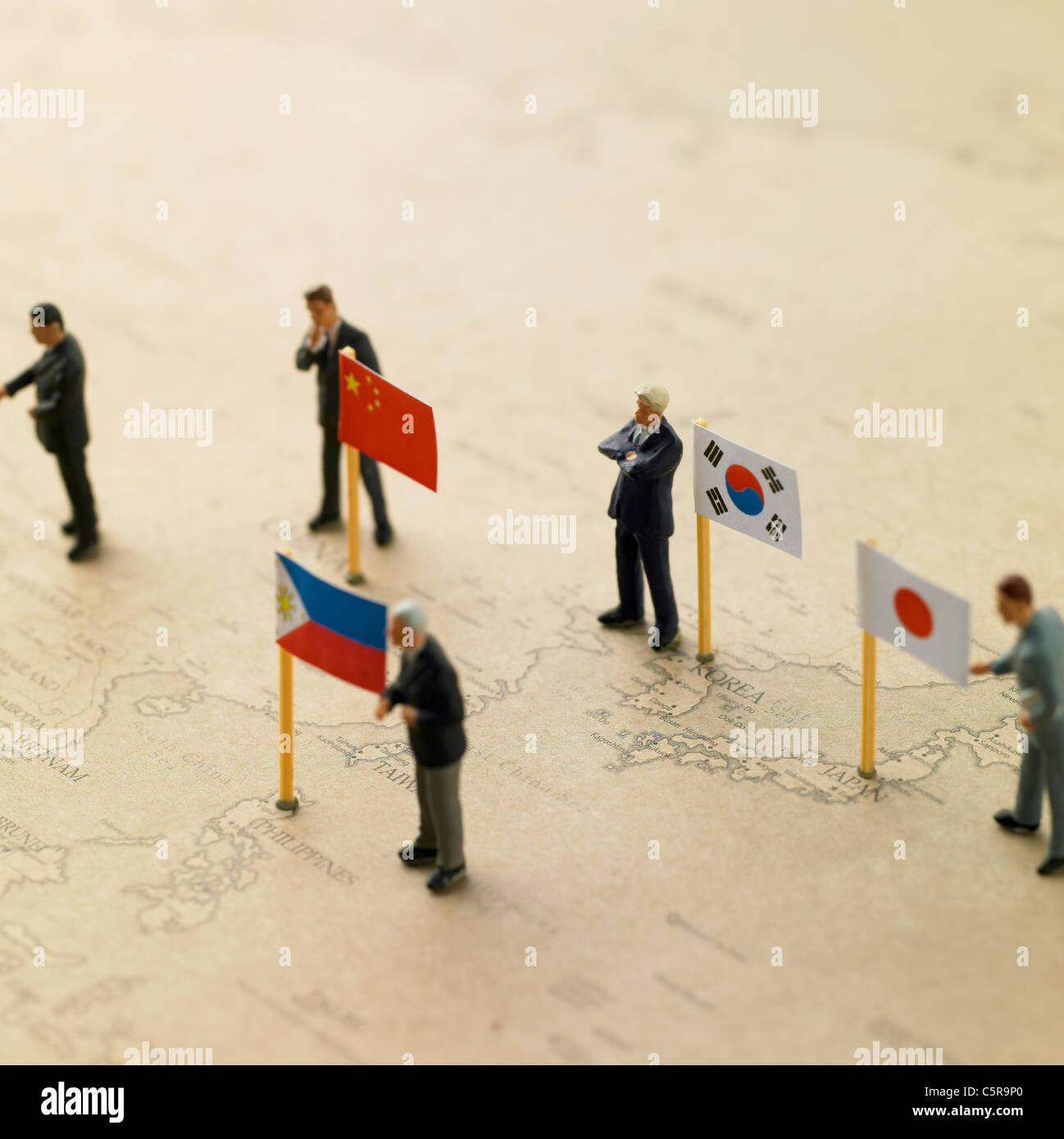 Flags from different countries on a world map with figurines Stock Photo