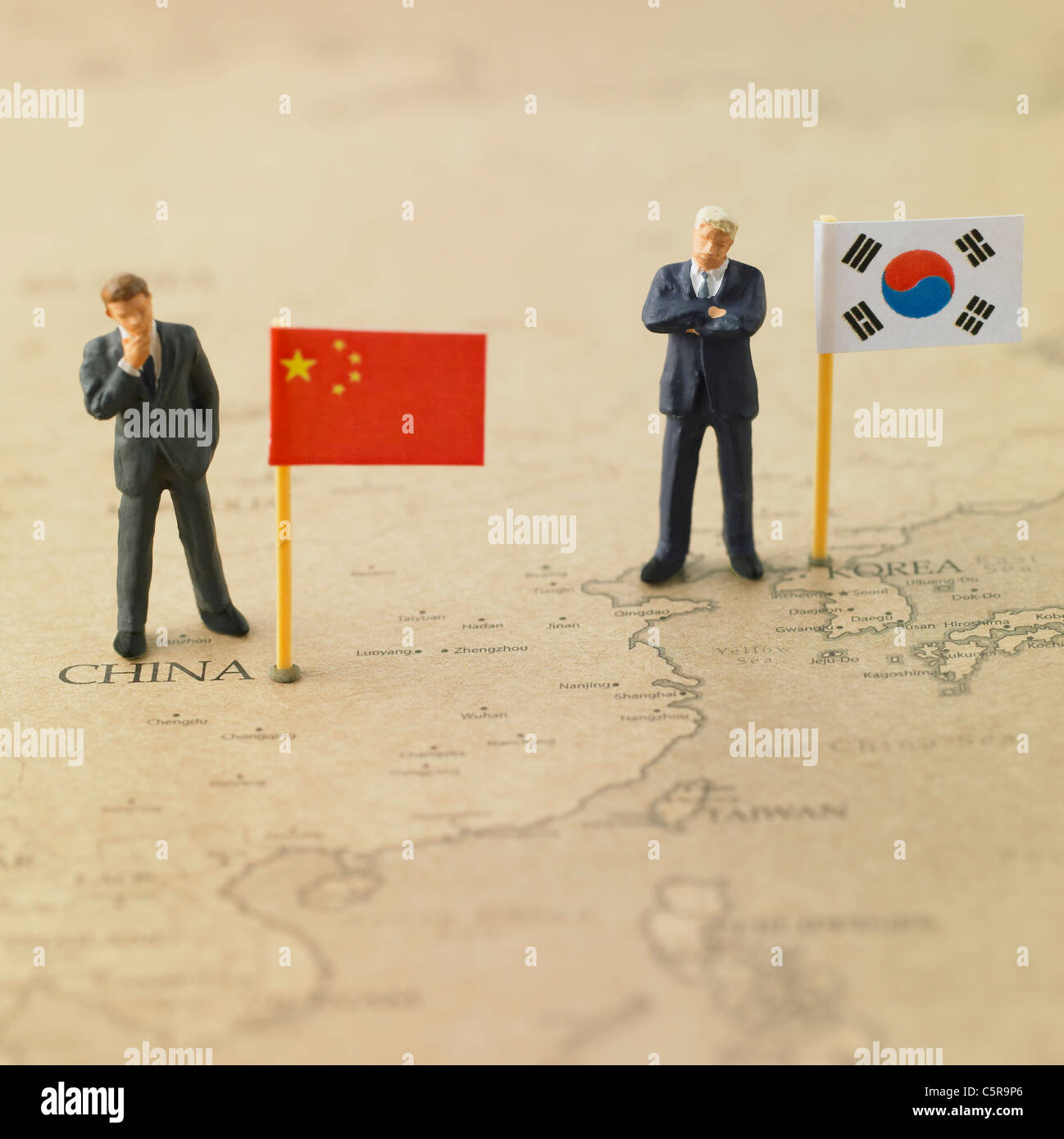 Flags from different countries on a world map with figurines Stock Photo