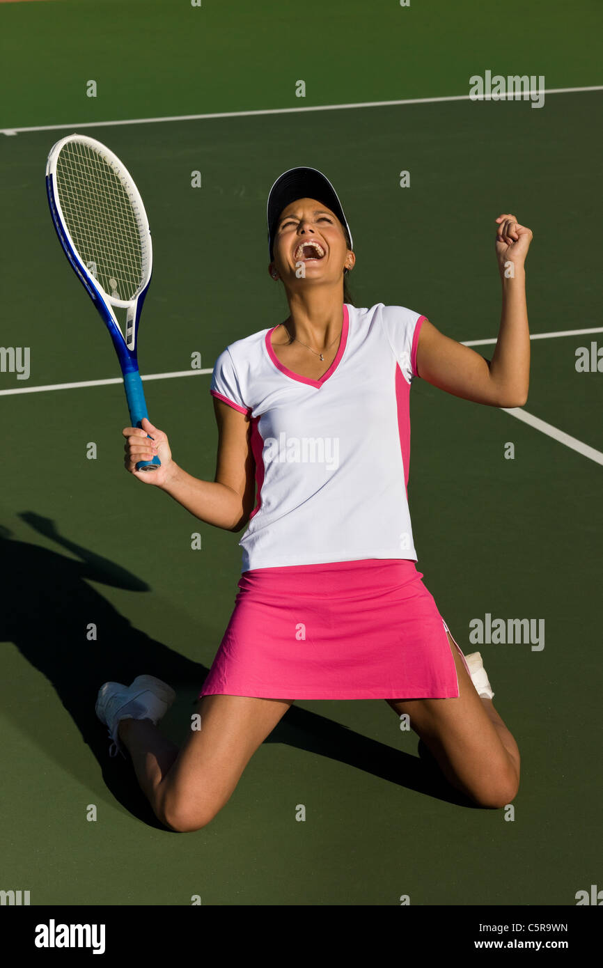 Tennis player celebrates winning match. Stock Photo