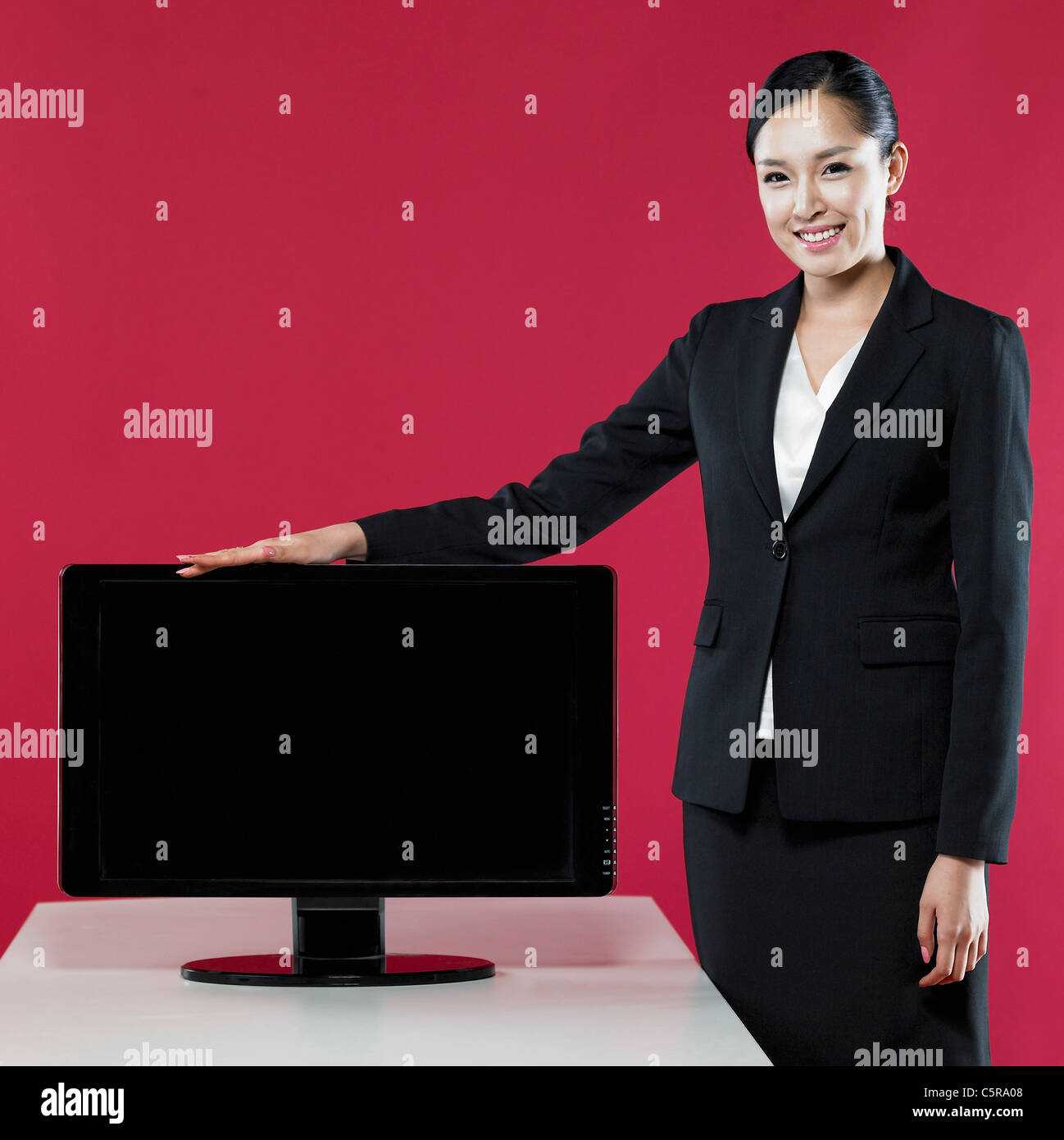 A woman touching a monitor Stock Photo