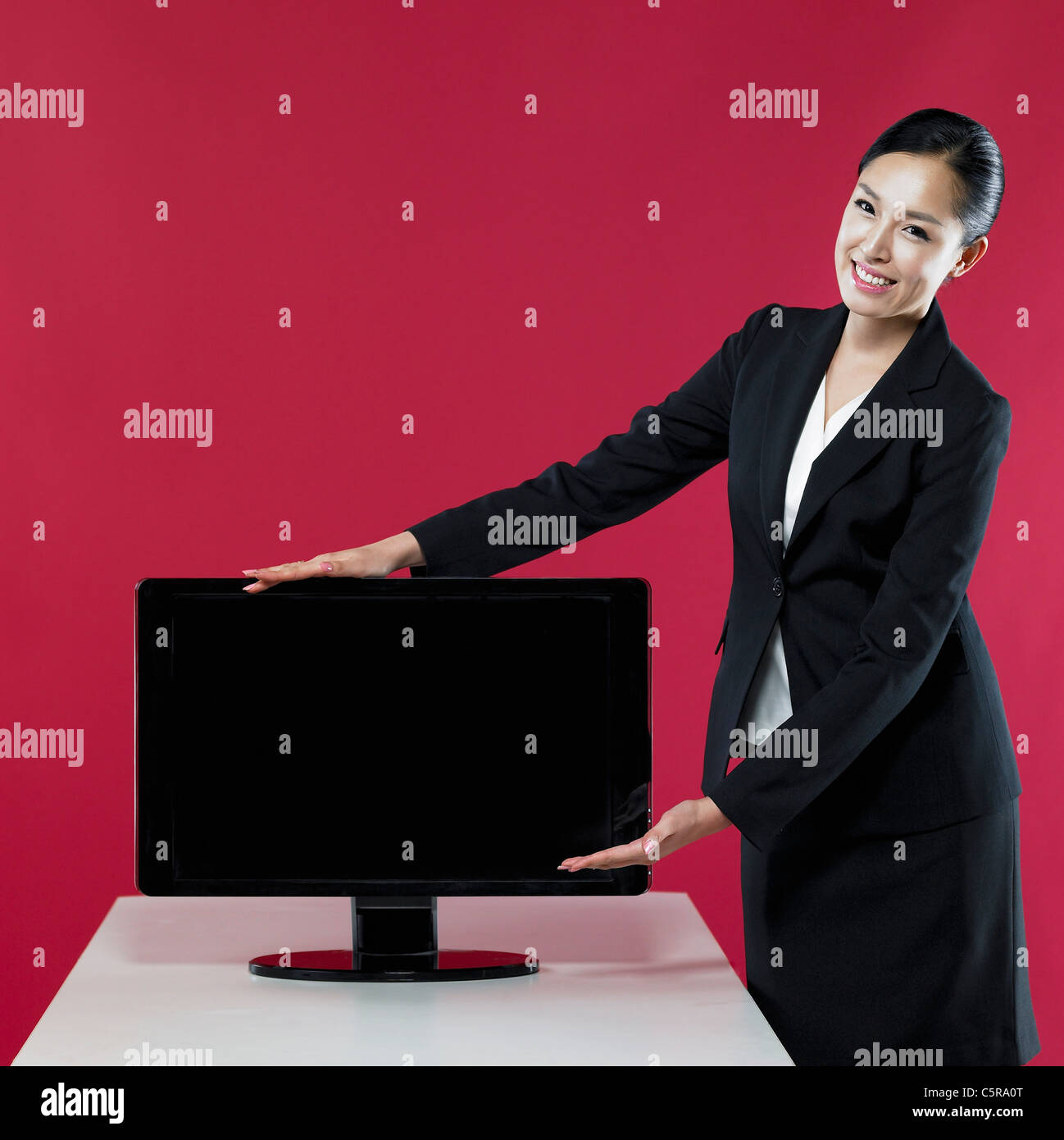 A woman introducing a monitor Stock Photo