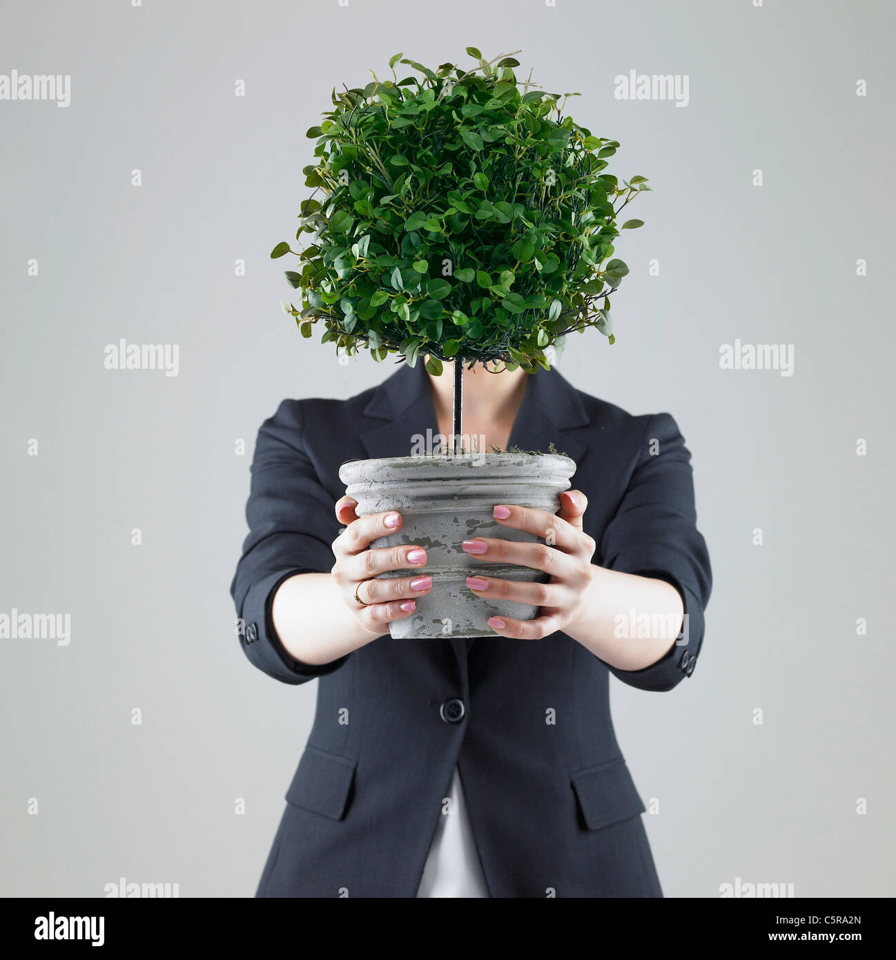 A woman holding a flower pot Stock Photo - Alamy