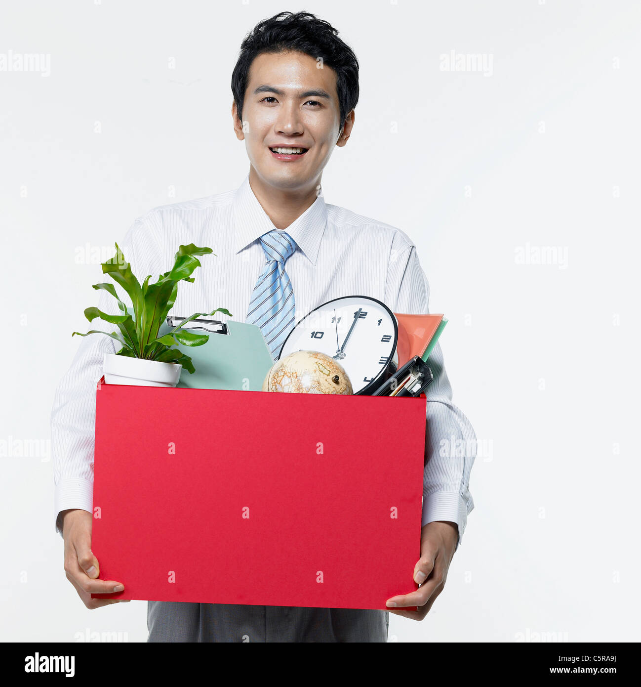 A man holding a box of many things Stock Photo
